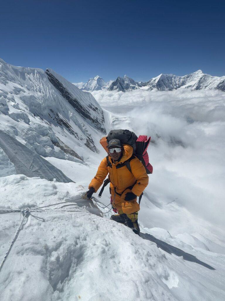 Climber above the clouds during Annapurna I ascent Spring 2026