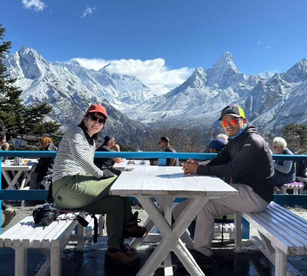 Trekkers relaxing at Everest View Hotel with mountain panorama Nepal
