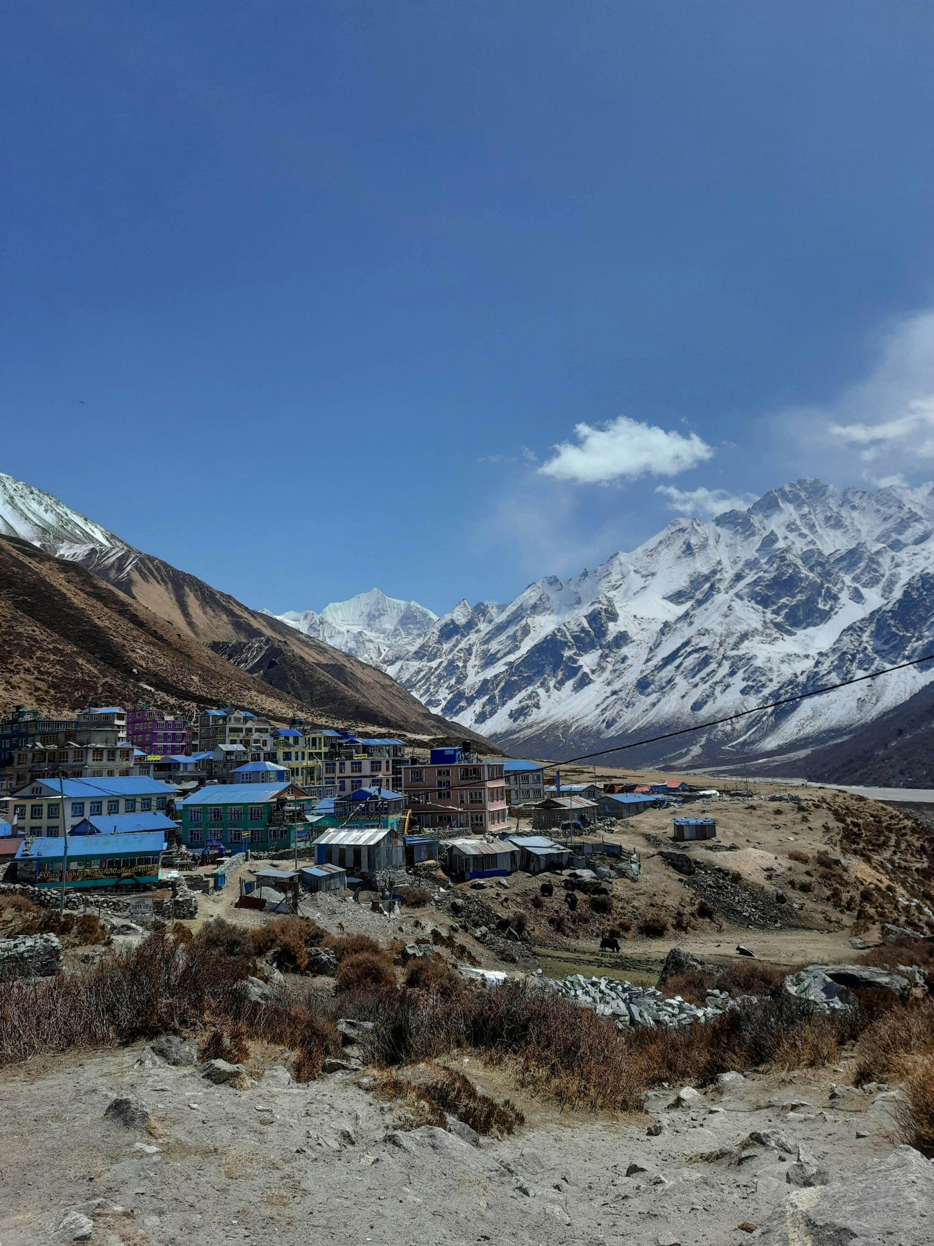 Traditional village nestled beneath snow capped mountains on the Langtang Valley Trek